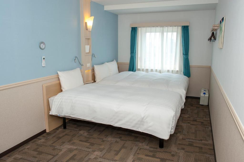 Postel nebo postele na pokoji v ubytování Toyoko Inn Daegu Dongseongro
