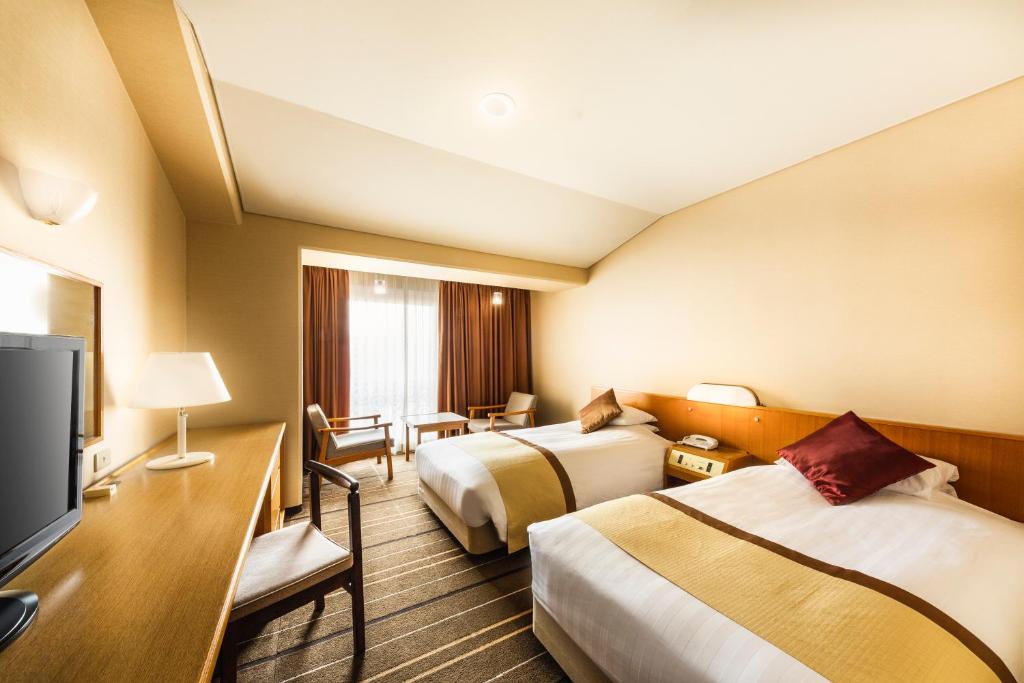 TV a/nebo společenská místnost v ubytování Senri Hankyu Hotel Osaka