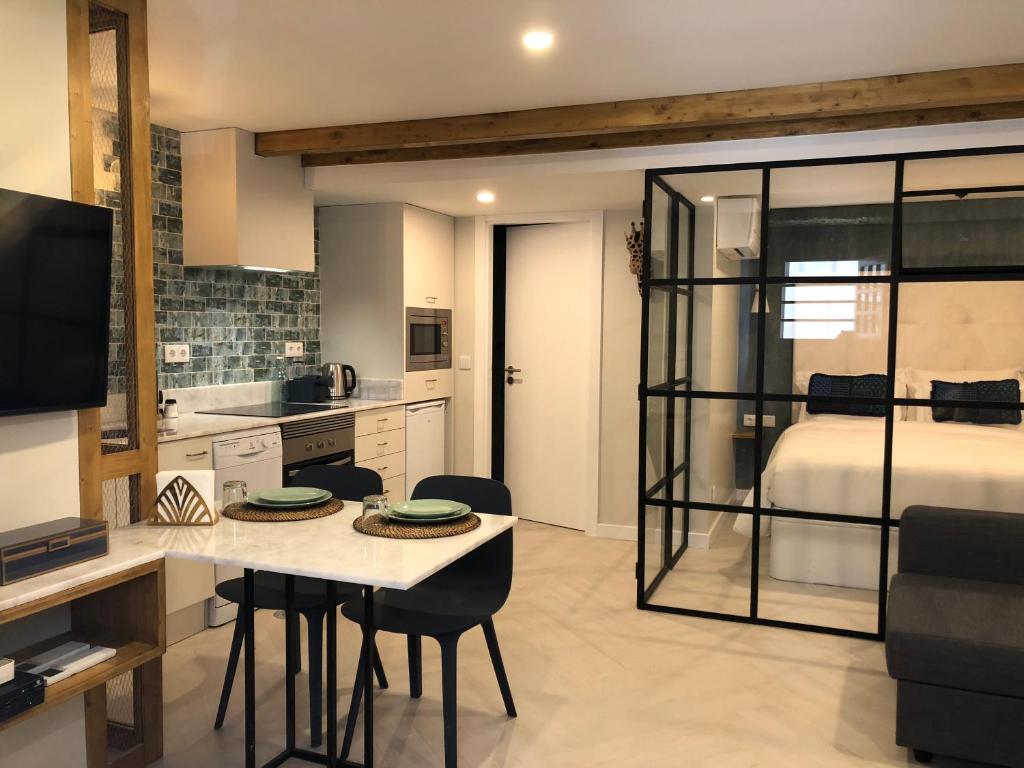 a kitchen and living room with a table and chairs at Canarios Apartments Catarina in Lisbon