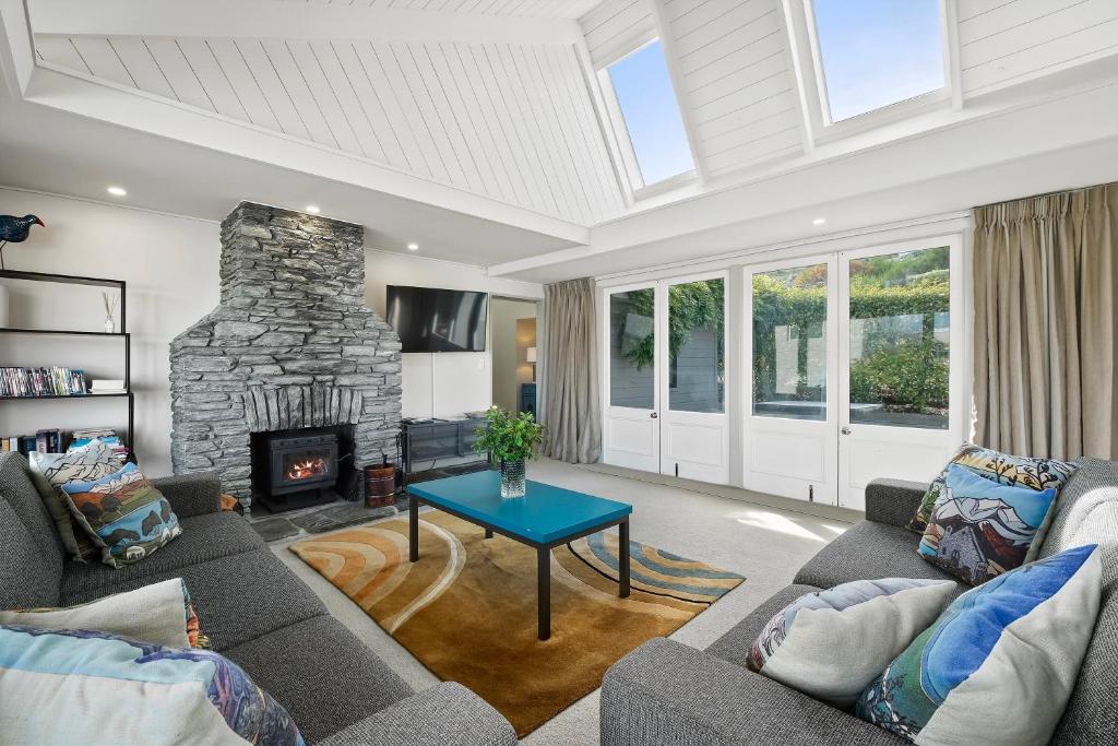 a living room with a couch and a fireplace at Suburb Retreat in Queenstown