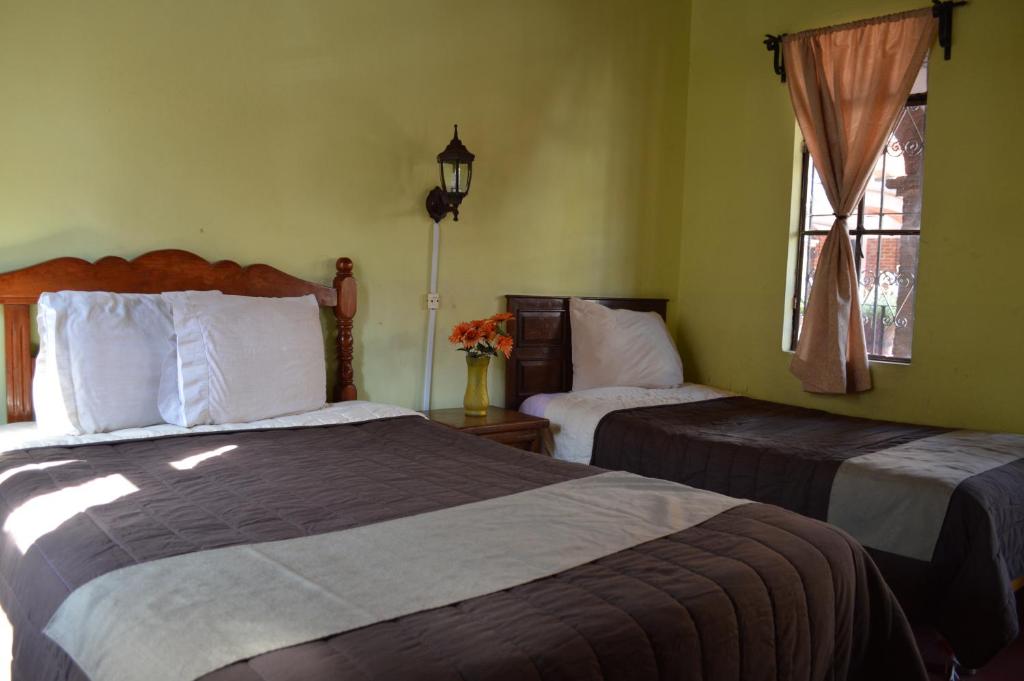 Postel nebo postele na pokoji v ubytování Hotel Dos Rios