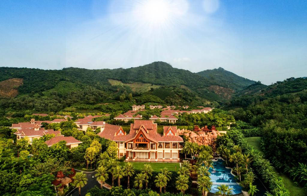 an aerial view of a resort with mountains in the background at Sanya Ocean Sonic Banling Hotspring Resort in Sanya