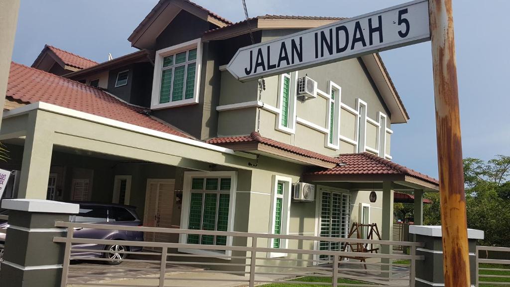 a house with a street sign in front of it at Homestay Melaka Sungai Udang (TSF Qaseh) in Kampong Baharu Sungai Udang