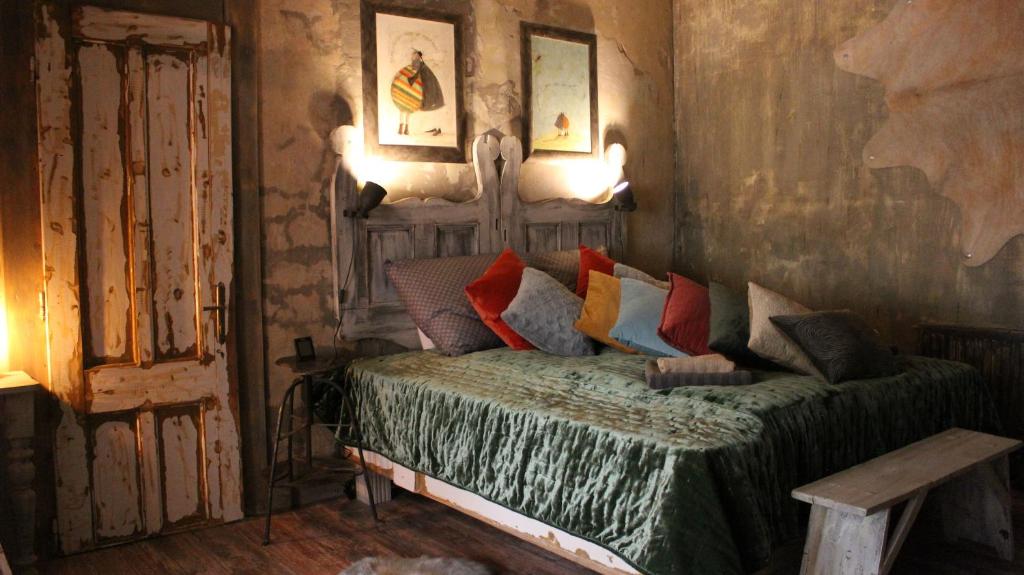 a bedroom with a bed with colorful pillows at VINTAGE in Old Town in Kecskemét