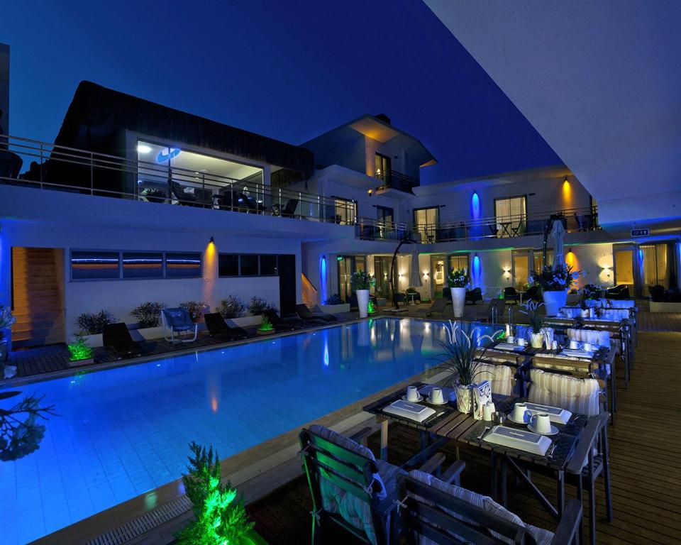 a resort with a swimming pool at night at The D Hotel Çeşme Resort in Çeşme