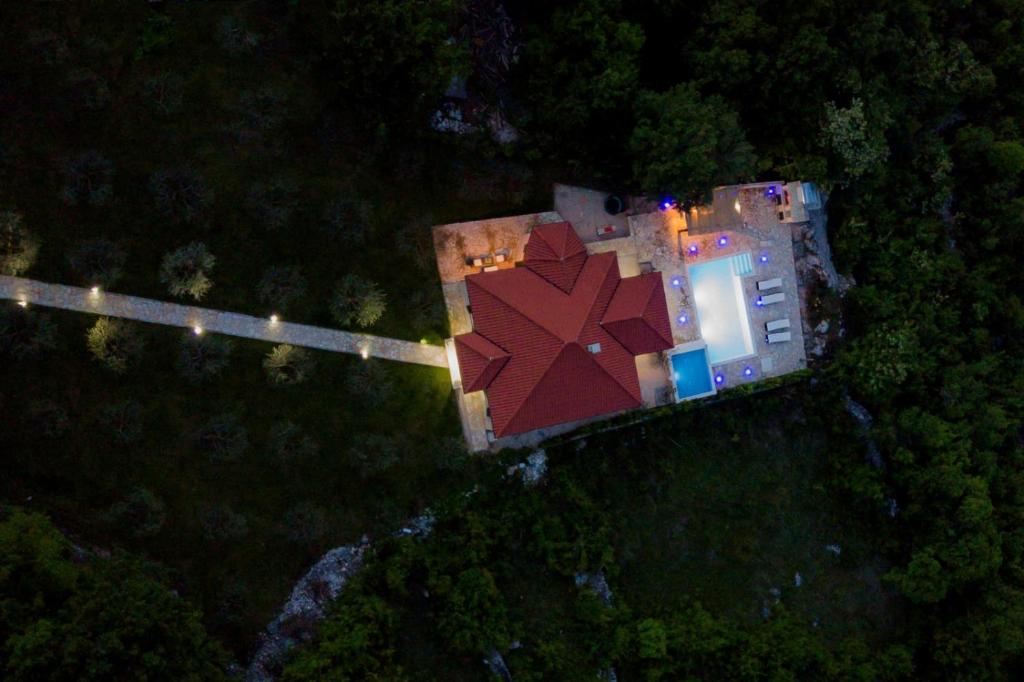 an aerial view of a house in the woods at night at Villa Maslina in Imotski