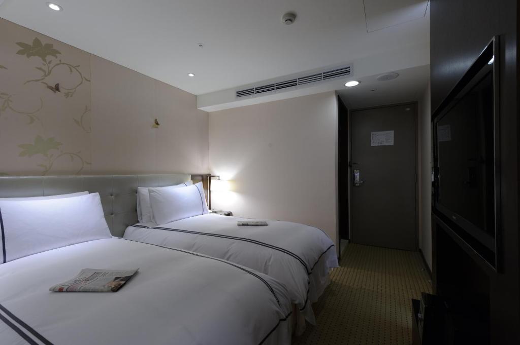 Postel nebo postele na pokoji v ubytování K Hotel Taipei Dunnan