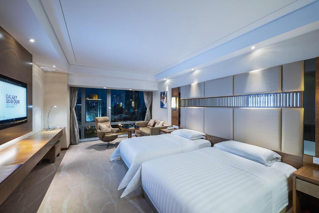 Postel nebo postele na pokoji v ubytování Galaxy minyoun Chengdu Hotel