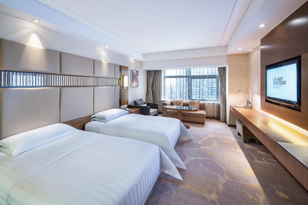 Postel nebo postele na pokoji v ubytování Galaxy minyoun Chengdu Hotel