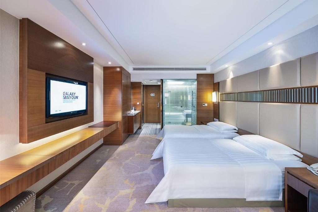Postel nebo postele na pokoji v ubytování Galaxy minyoun Chengdu Hotel
