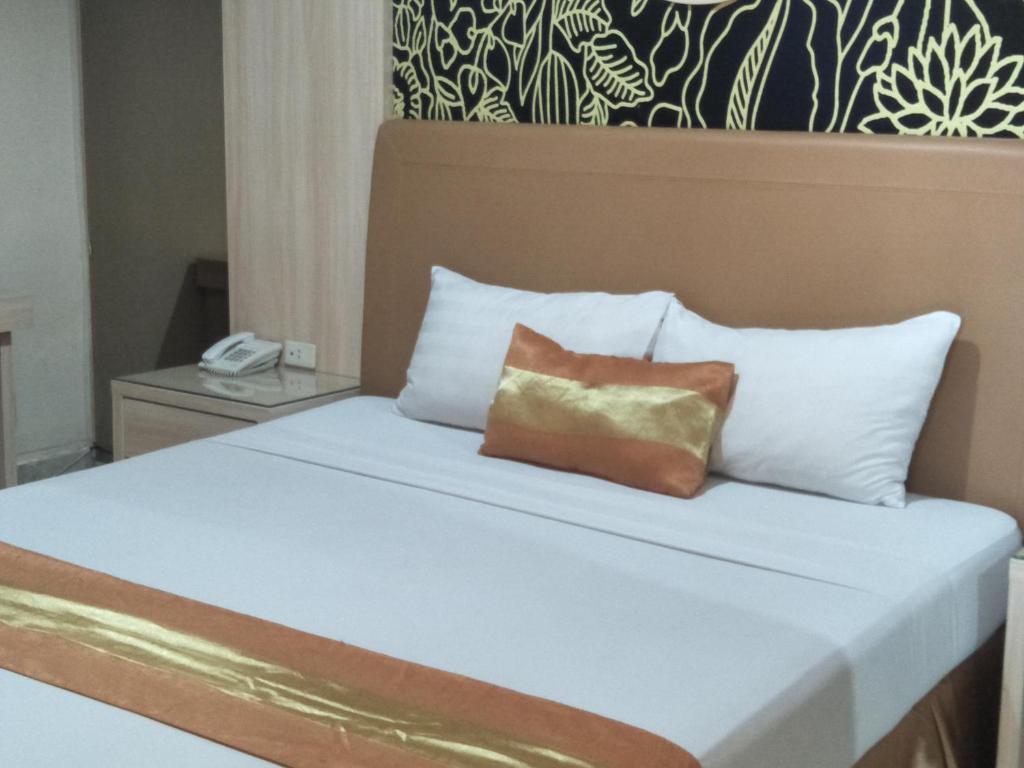 Postel nebo postele na pokoji v ubytování Hotel Grand Rosela
