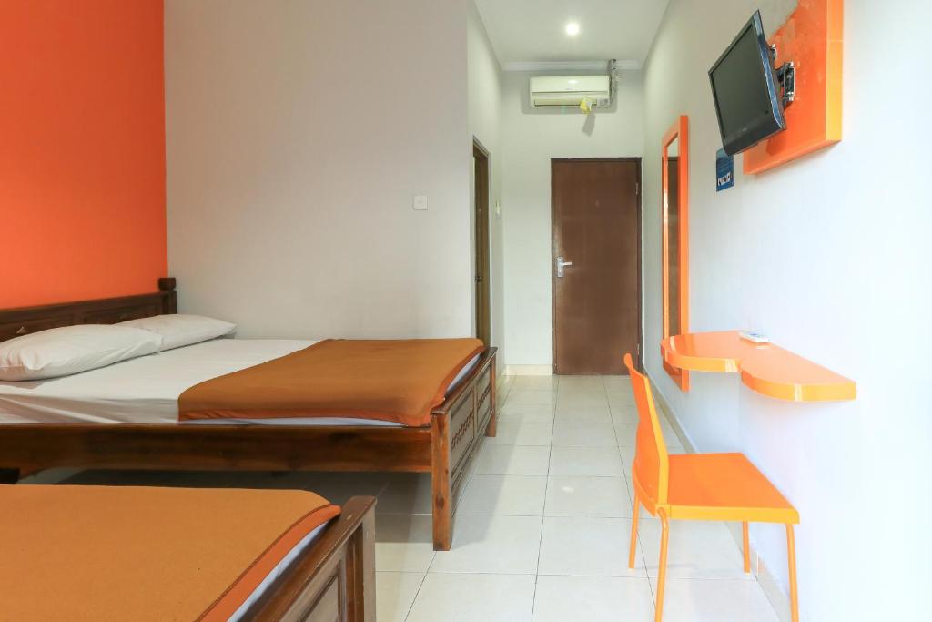 Postel nebo postele na pokoji v ubytování Hotel Warta Putra