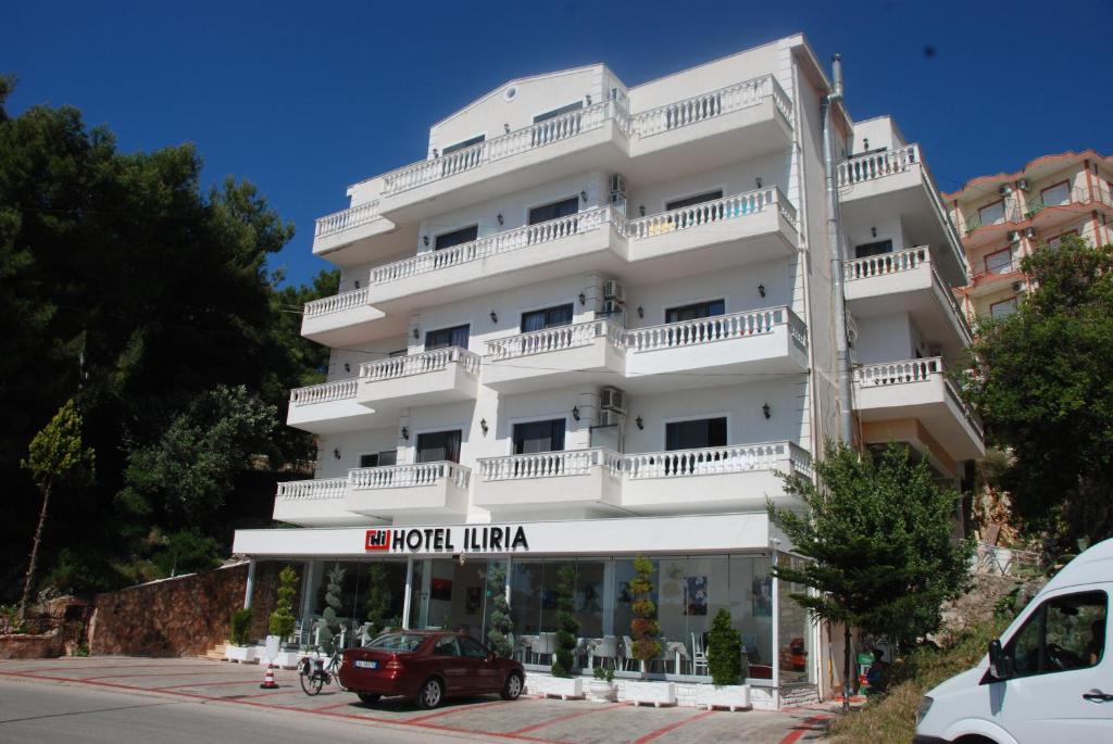 a white building with a sign that reads hotel filka at Hotel Iliria in Sarandë