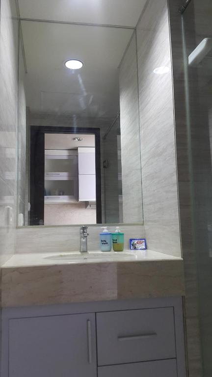 a bathroom with a sink and a mirror at Ruby Apartment #2 in Yogyakarta
