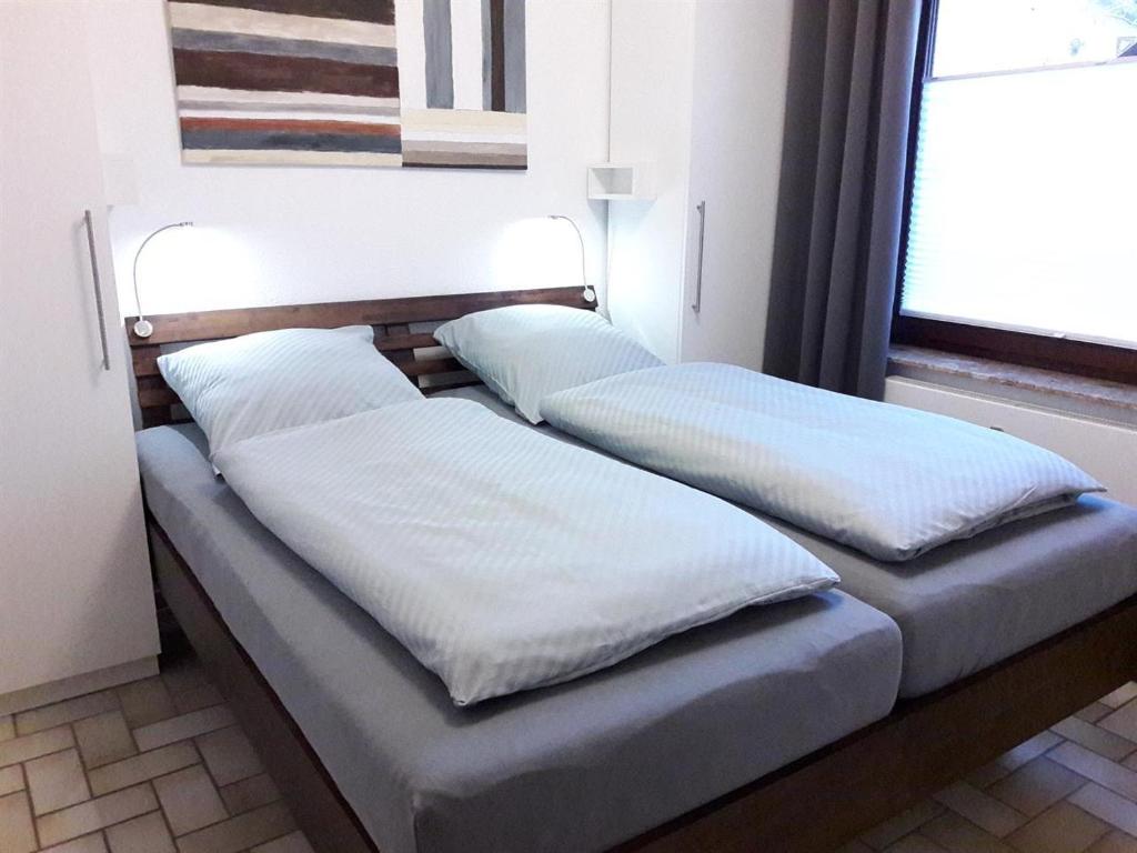 two beds sitting next to each other in a room at Sandpeter 1 in Sankt Peter-Ording