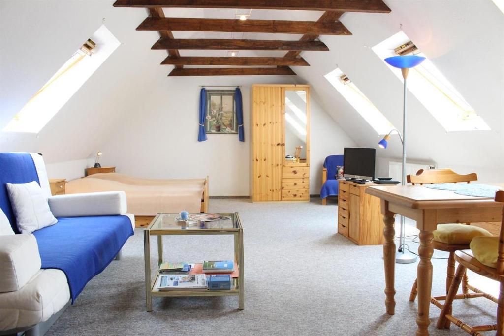 a living room with a blue couch and a table at Ferienwohnung Lumme in Poppenbüll