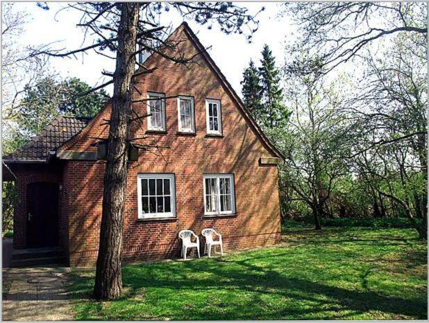 a house with two white chairs in front of it at Haus Bernstein in Tating