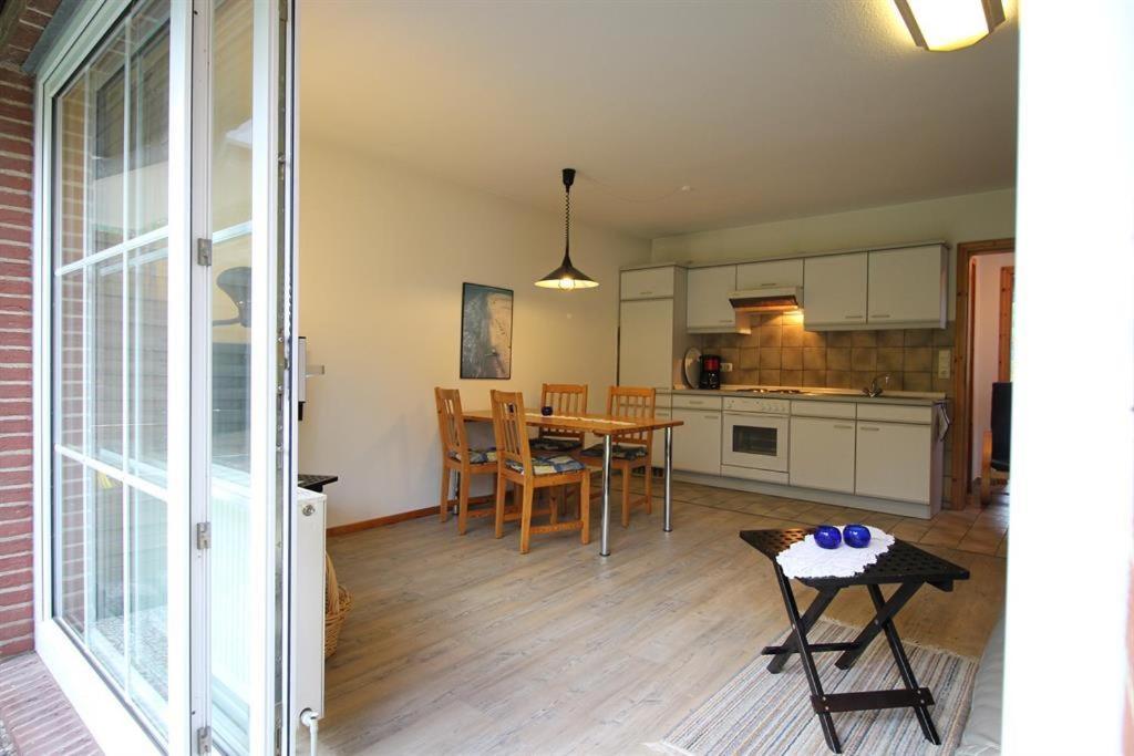 a kitchen and dining room with a table and a dining room at Ferienwohnung Remuß in Garding