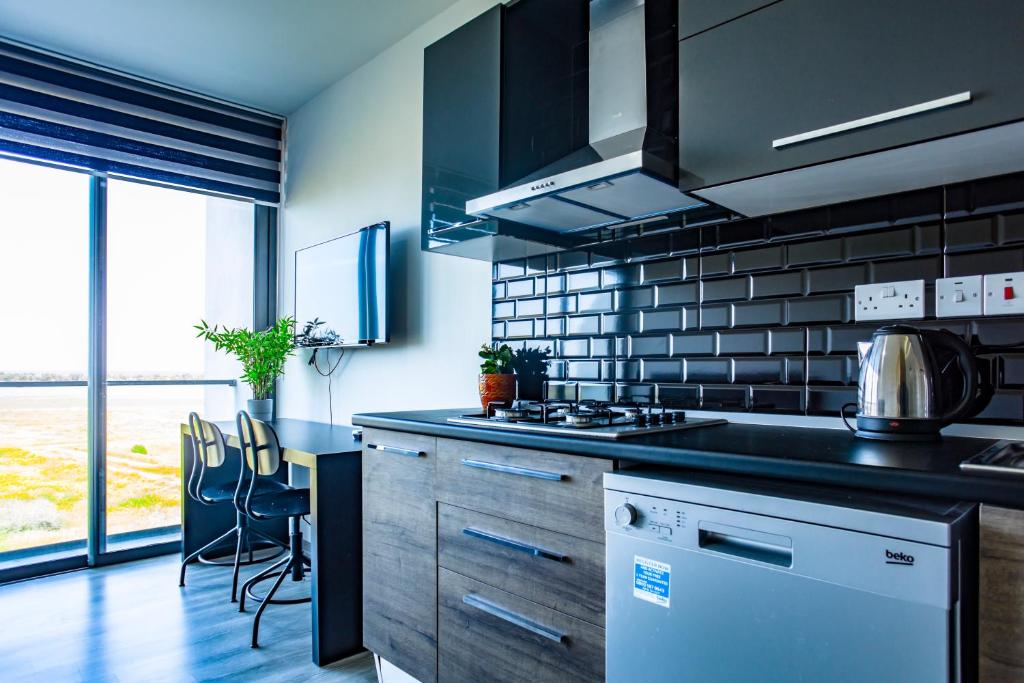 a kitchen with a stove and a counter top at Hotel Standard Stylish Studio - contactless check-in&check out in Famagusta