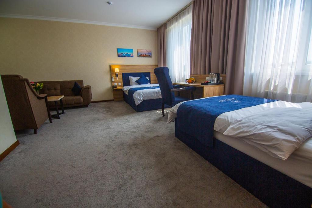 Postel nebo postele na pokoji v ubytování Rayan Hotel