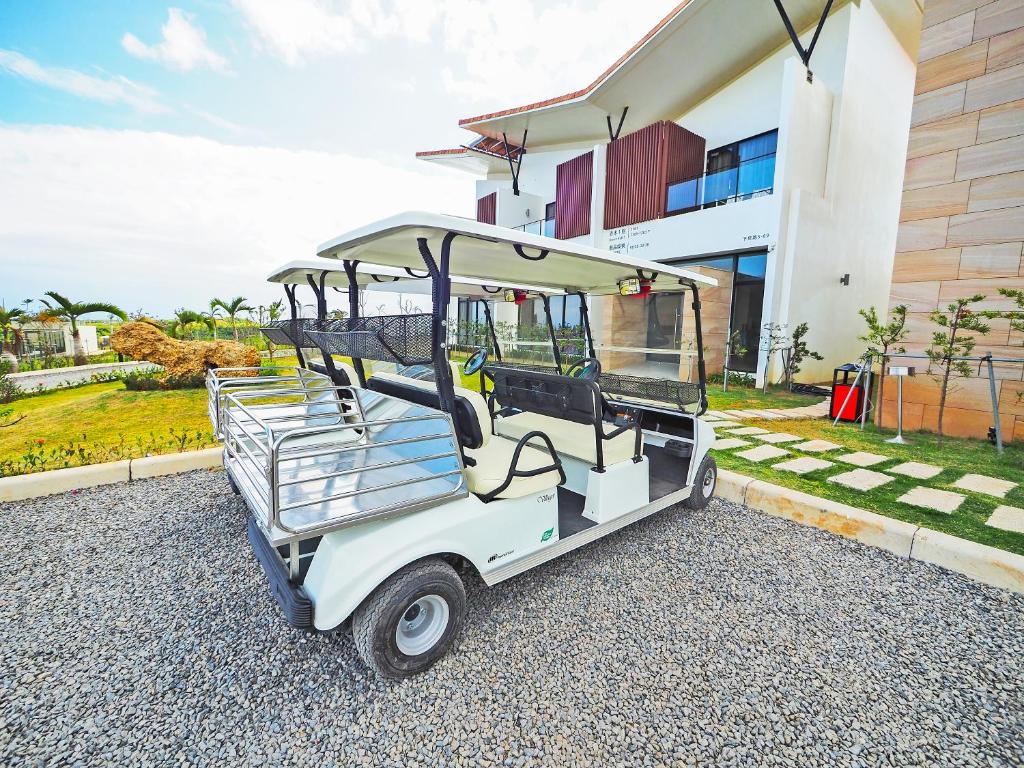 a golf cart parked in front of a building at SkyeBay Club in Hengchun