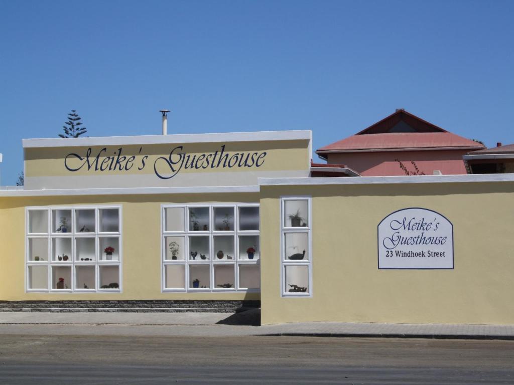 a yellow building with a sign for a whistler christmas store at Meike's Guesthouse in Swakopmund