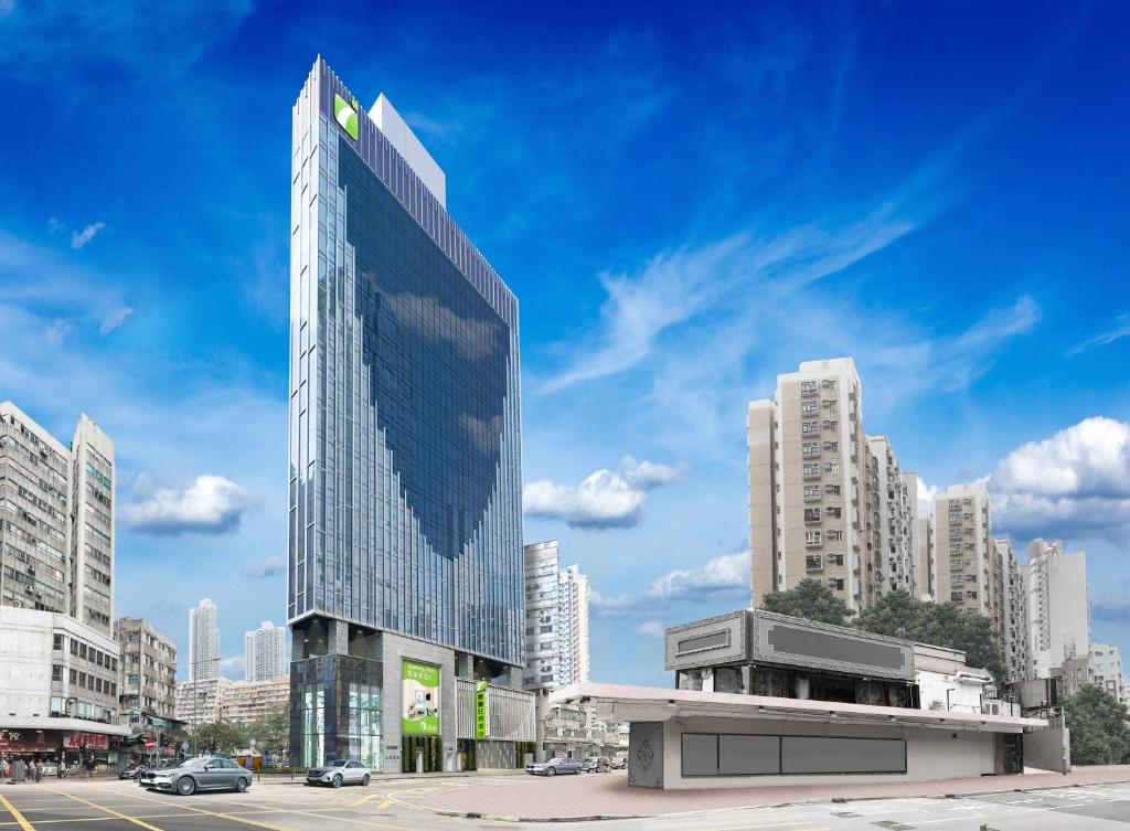 a tall glass building in a city with buildings at iclub Mong Kok Hotel in Hong Kong