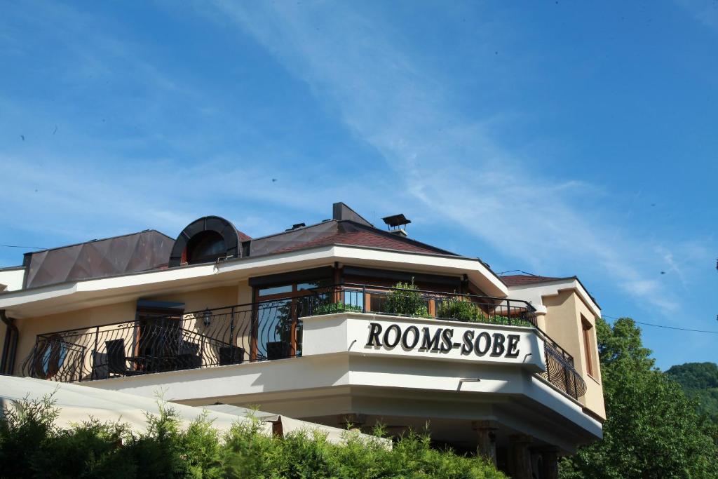 a building with a sign that reads roososaosa at Provence rooms in Banja Luka