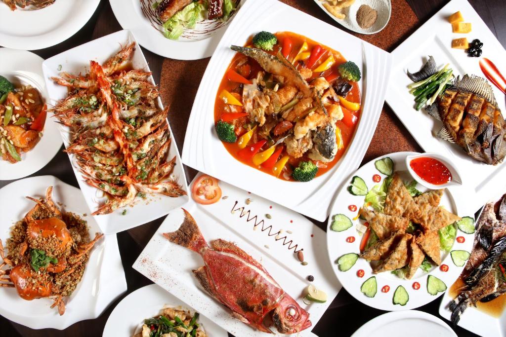 a table with plates of food on it at SkyeBay Club in Hengchun