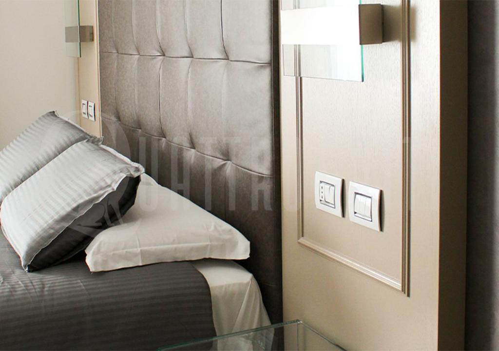 Postel nebo postele na pokoji v ubytování Quattro Gatti Rooms&Suite