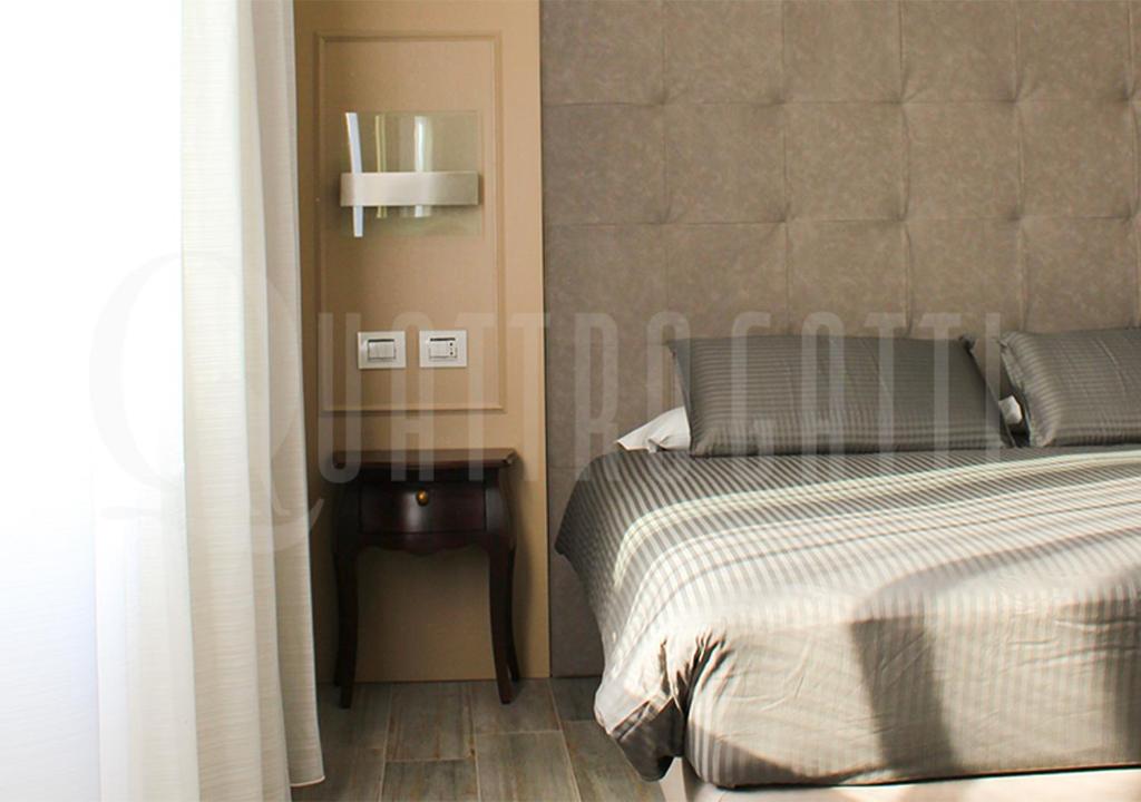 Postel nebo postele na pokoji v ubytování Quattro Gatti Rooms&Suite