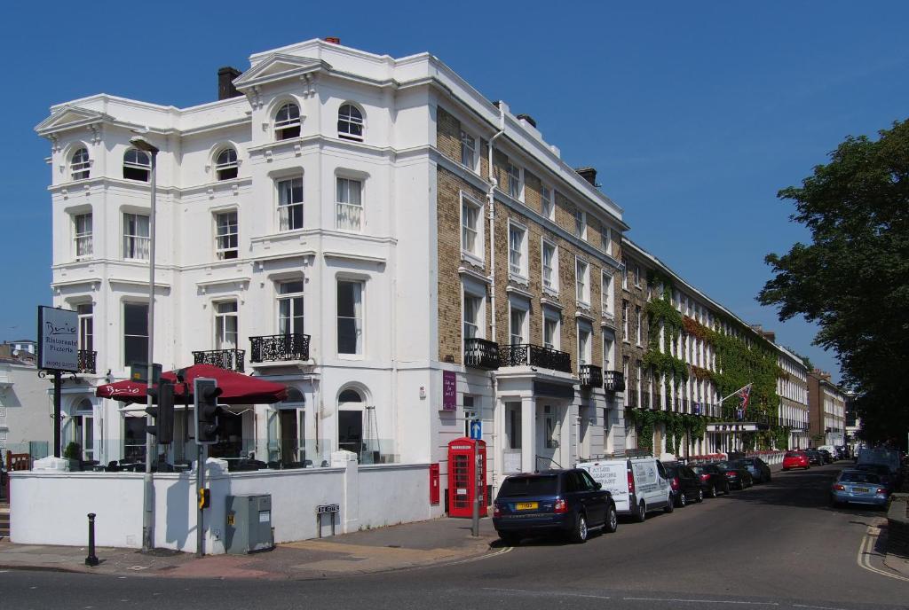 a white building on the corner of a street at The Chatsworth Hotel in Worthing