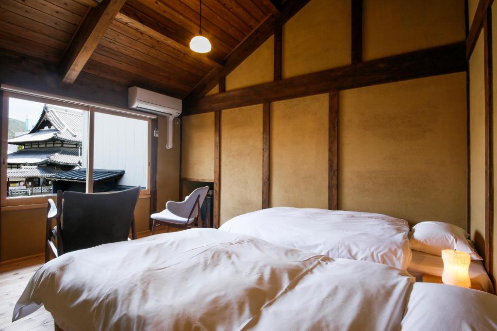 Postel nebo postele na pokoji v ubytování Kariya Ryokan Q