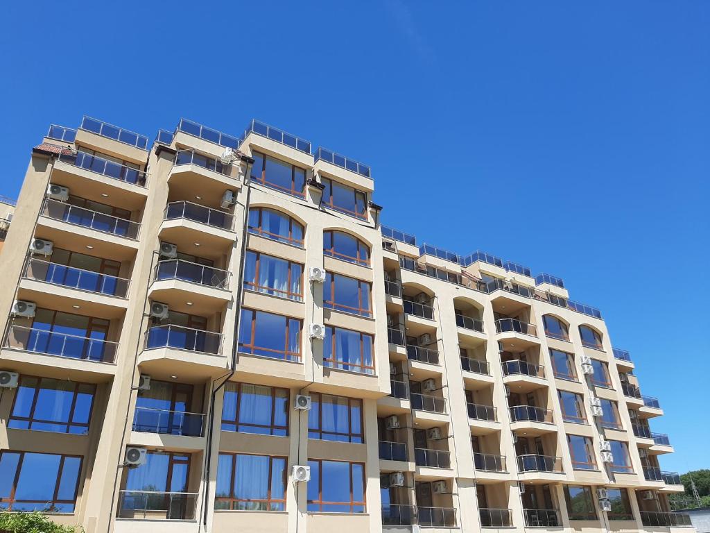 an apartment building with blue sky in the background at Vesta Riviera - Free Parking in Golden Sands