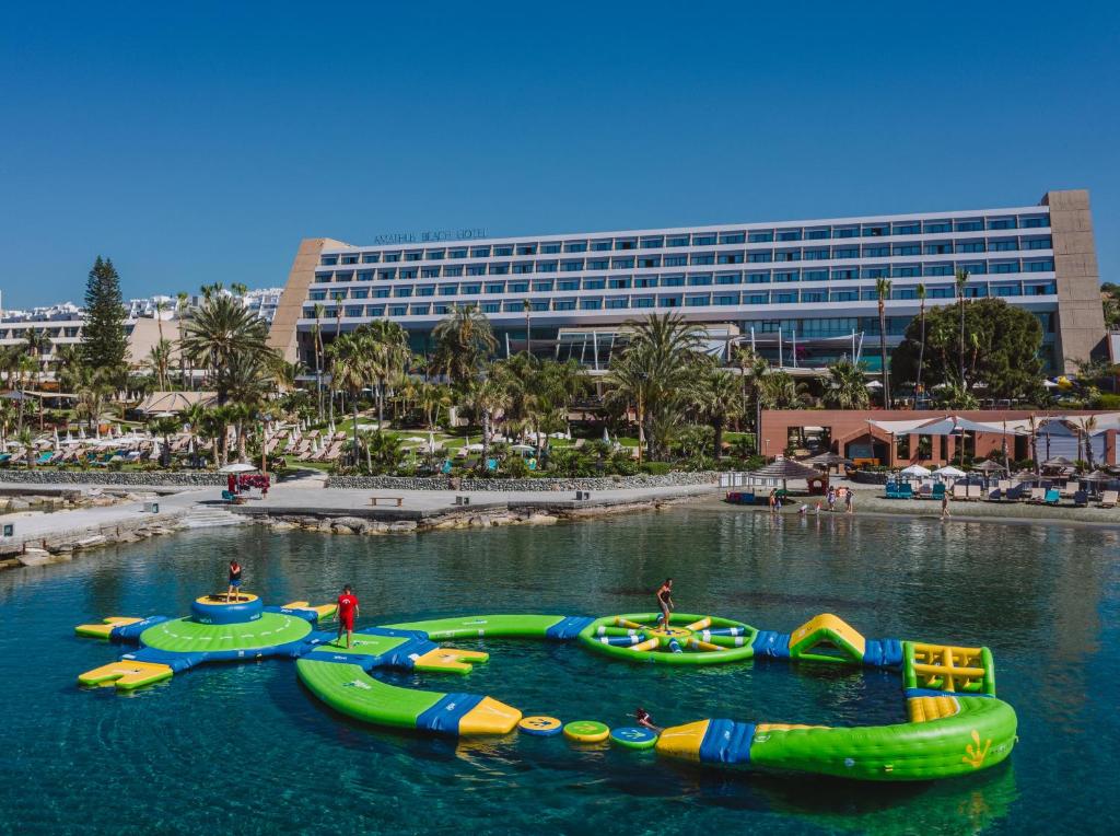 a group of inflatable boats in a body of water at Amathus Beach Hotel Limassol in Limassol