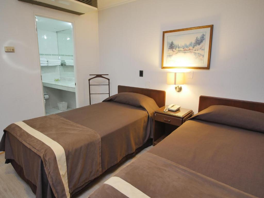 A bed or beds in a room at Apart Hotel Diego De Almagro