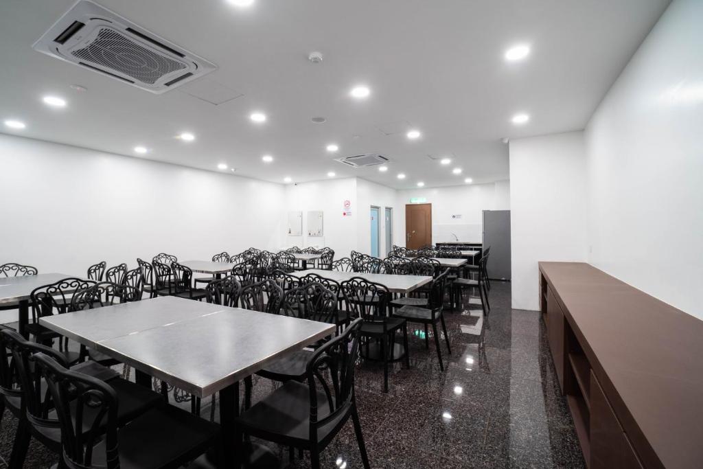 a dining room with tables and chairs in a room at Crystal Garden Hotel (Tasik Selatan) in Kuala Lumpur