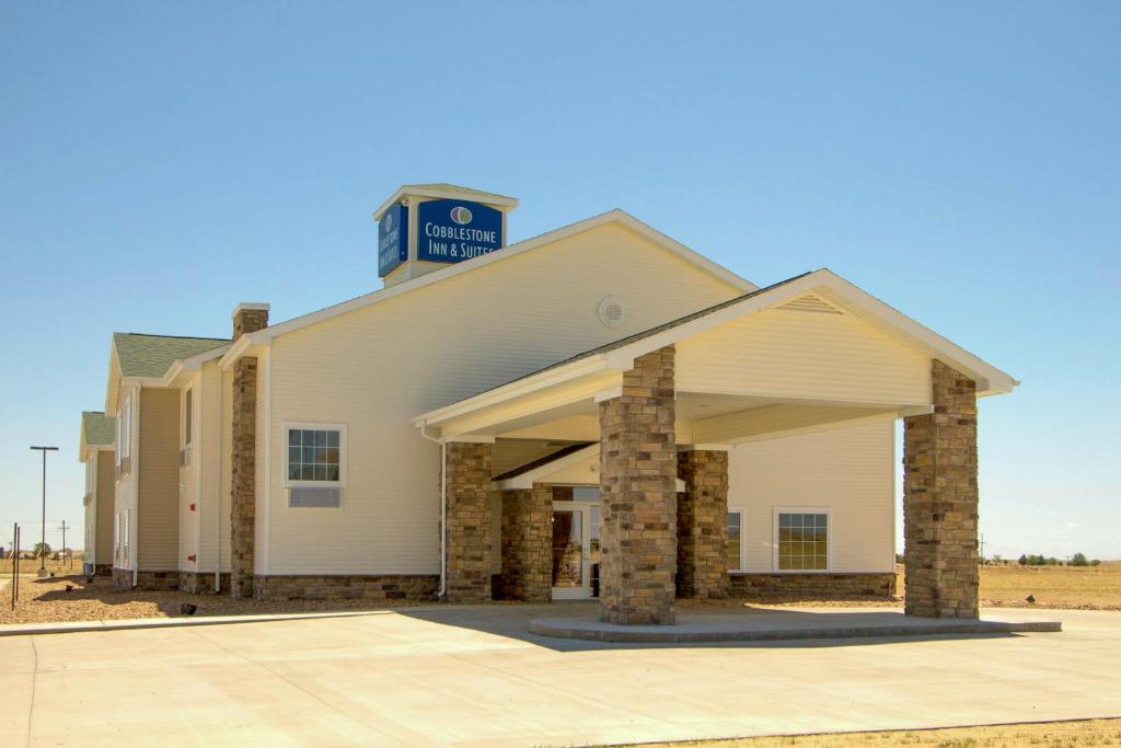 a building with a clock on top of it at Cobblestone Inn & Suites - Eads in Eads