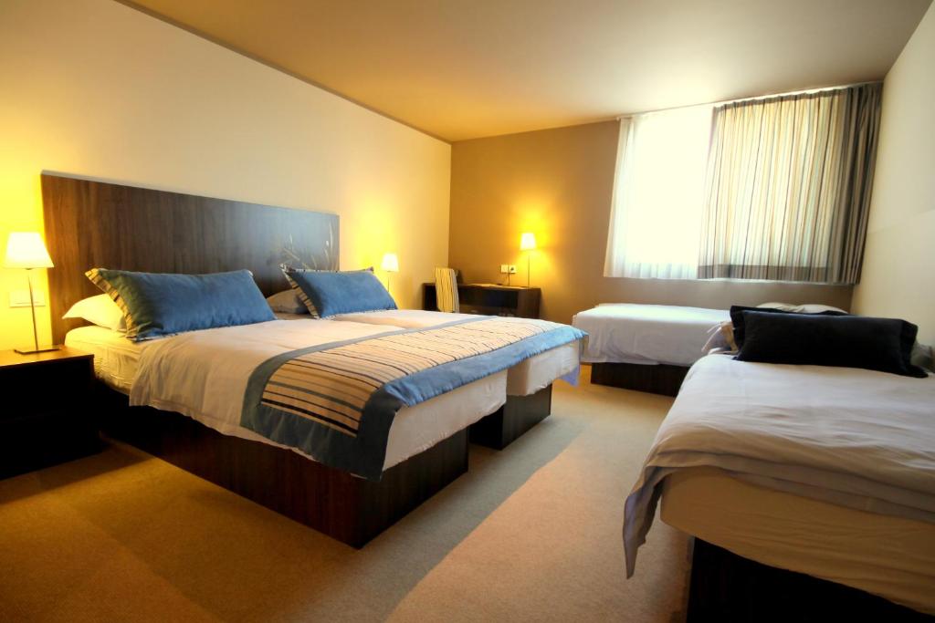Postel nebo postele na pokoji v ubytování Ambient Hotel
