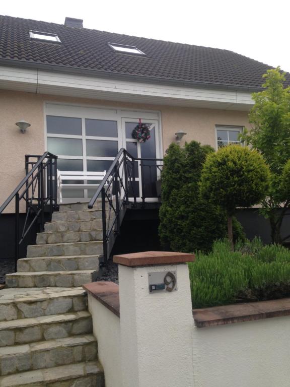 a house with stairs leading to the front door at Loreley bed and breakfast in Bornich