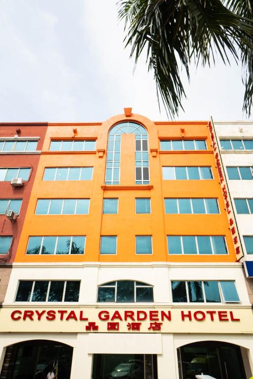 an orange hotel with a sign in front of it at Crystal Garden Hotel (Tasik Selatan) in Kuala Lumpur