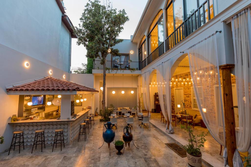 an indoor patio with a bar and tables and chairs at Delight Deluxe Hotel in Antalya