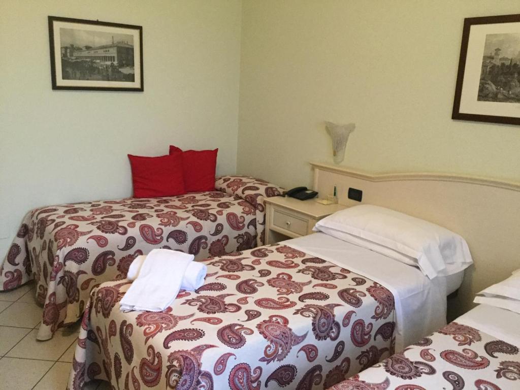 Postel nebo postele na pokoji v ubytování Albergo Il Gufo