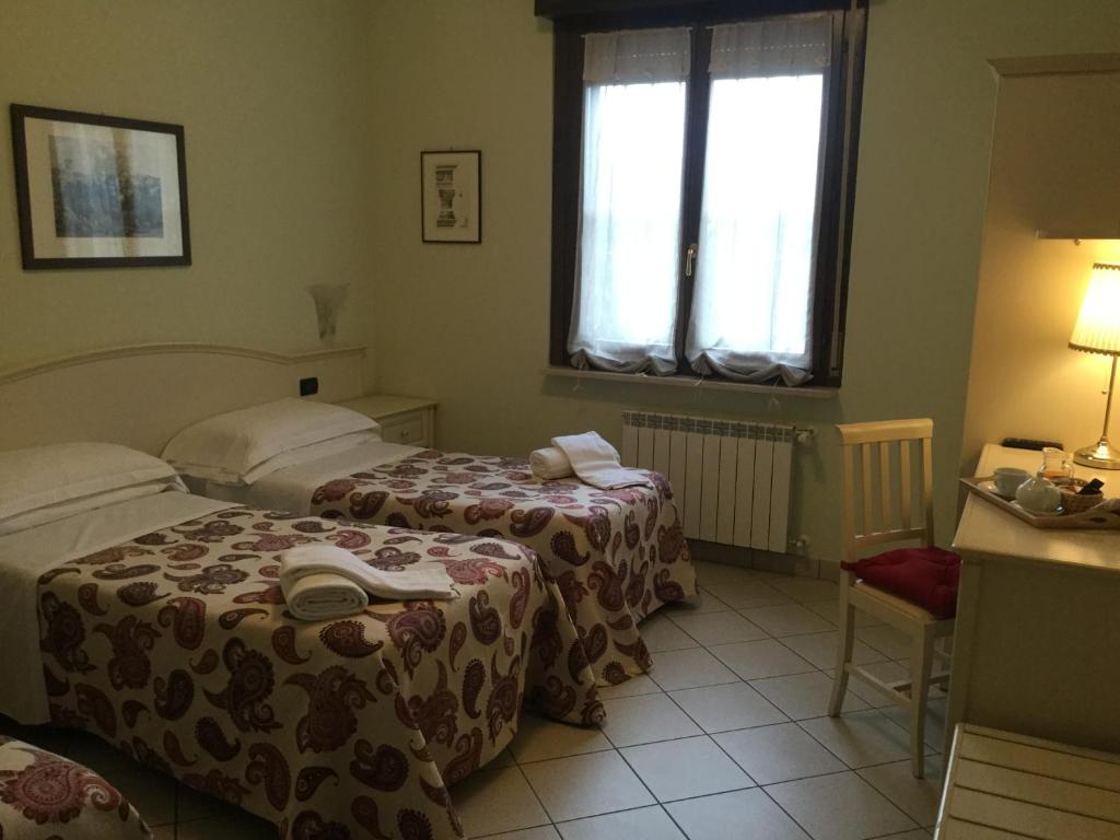 Postel nebo postele na pokoji v ubytování Albergo Il Gufo