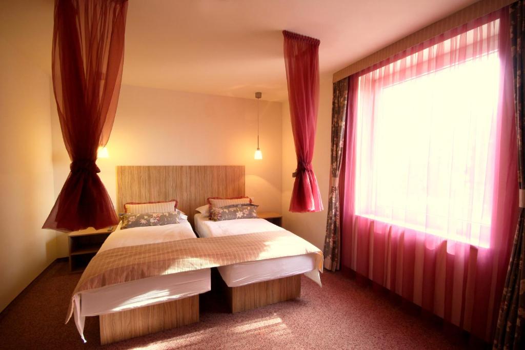 Postel nebo postele na pokoji v ubytování Ambient Hotel