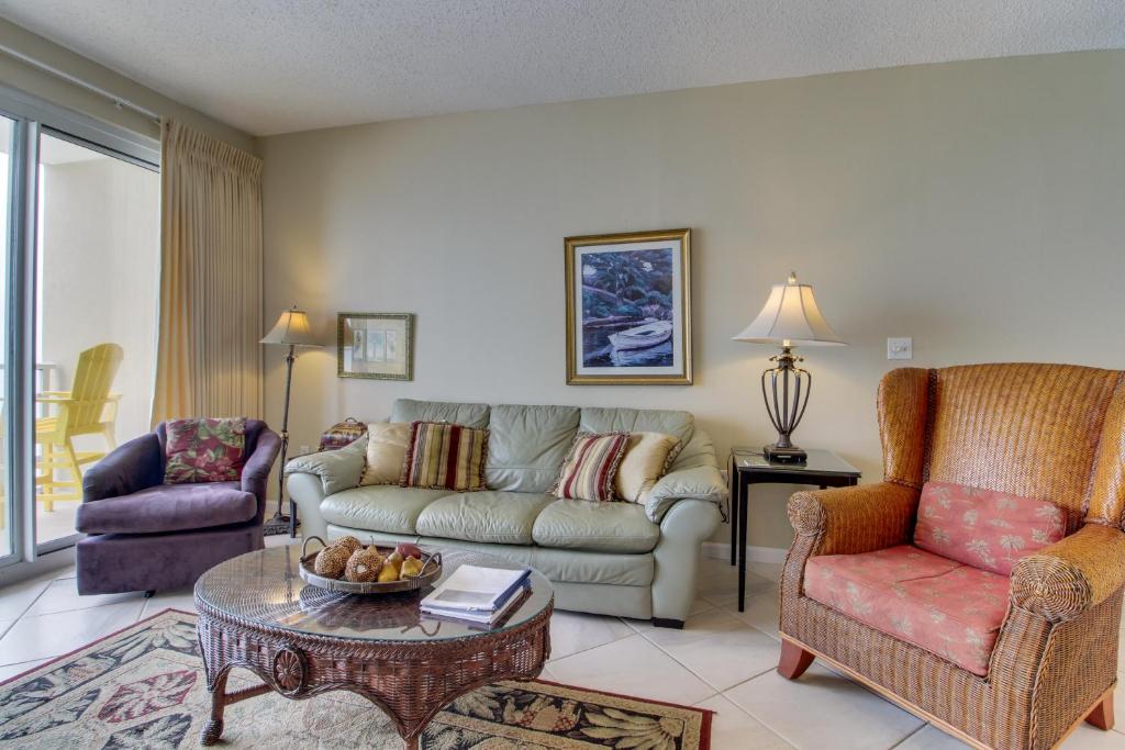 a living room with a couch and a table and chairs at Sterling Sands 708 Destin (Condo) in Destin