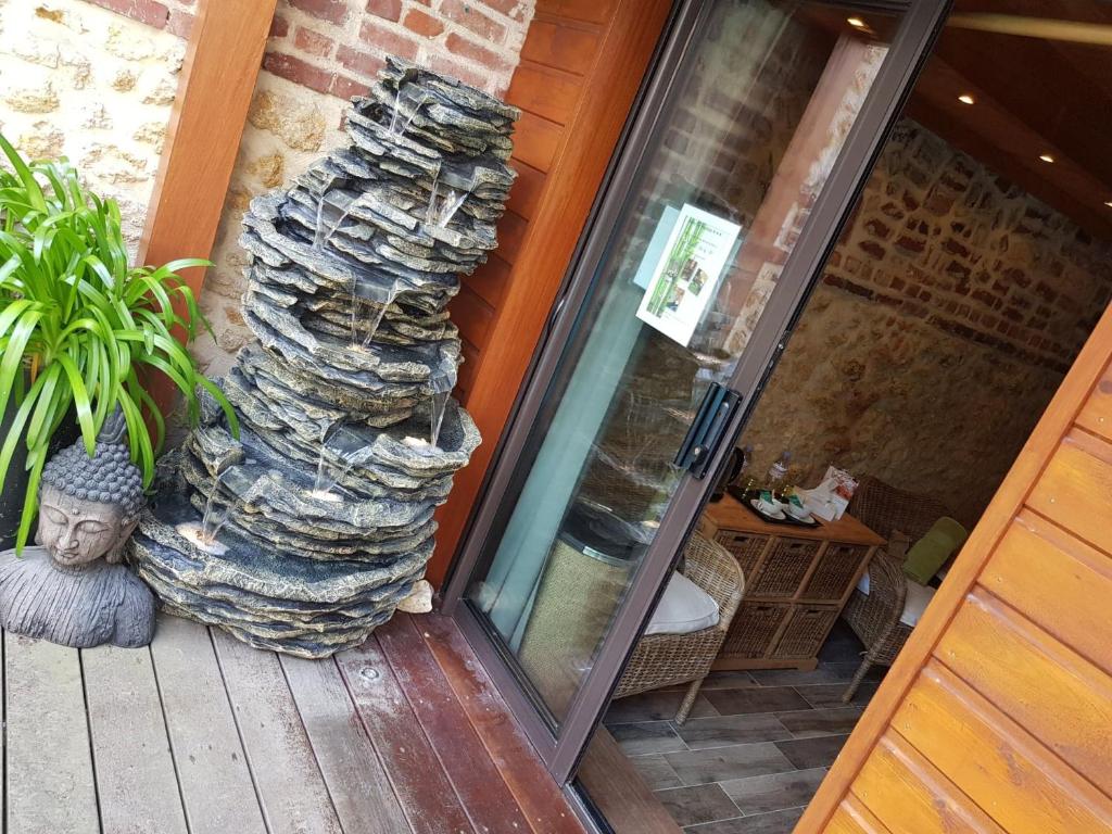 a stack of rocks sitting on a porch at Le Trophée Boutique Hôtel Spa- La Loggia Appart'hôtel in Deauville