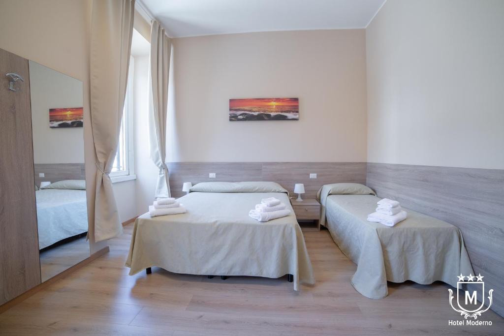 Postel nebo postele na pokoji v ubytování Hotel Moderno