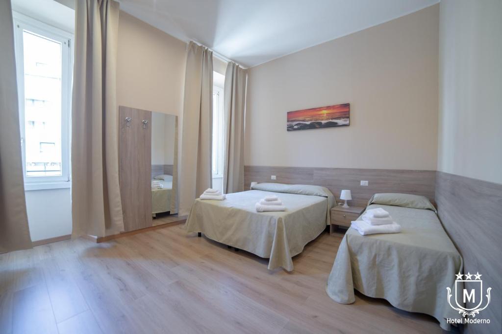 Postel nebo postele na pokoji v ubytování Hotel Moderno