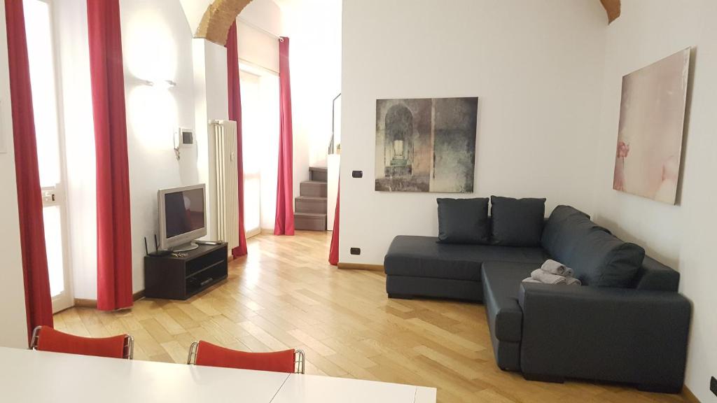 - un salon avec un canapé et une télévision dans l'établissement Casa Maltese, à Turin
